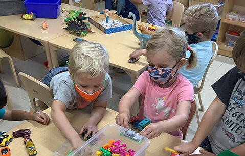 Young girl in kindergarten smiling at camera