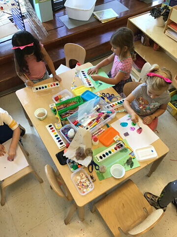 Kids using watercolors at an art table
