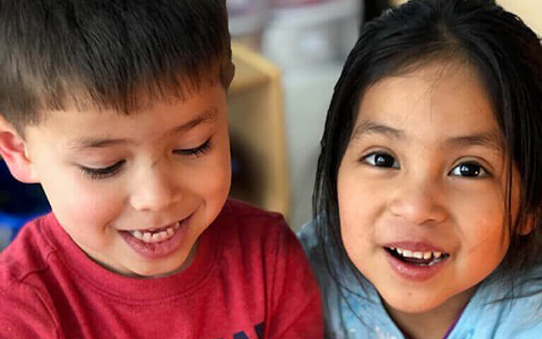 Two children smiling at camera